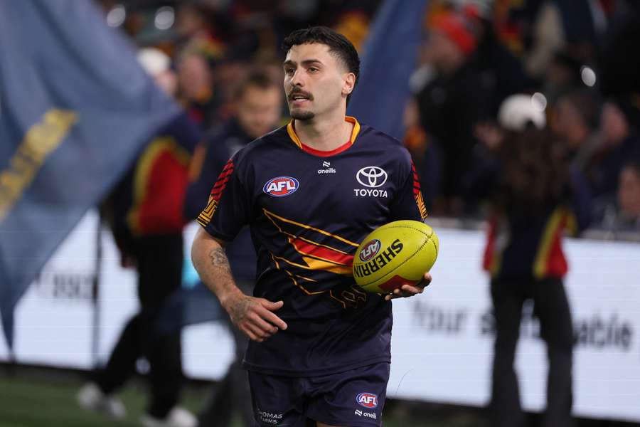 Izak Rankine warms up before his Round 23 appearance against Collingwood.