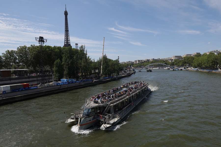 A tourist boat is navigated on the Seine river