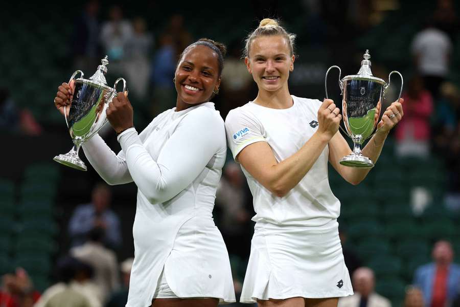 Taylor Townsend and Katerina Siniakova celebrate with their trophies after winning the women's doubles final