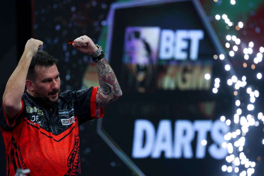 Clayton celebrates after coming from behind to beat Van Gerwen in Brighton