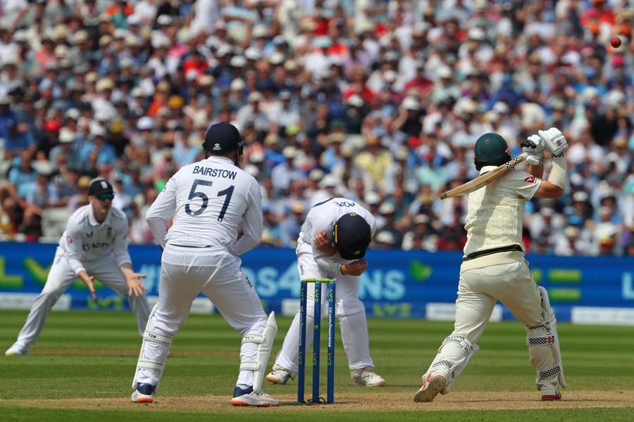 England fielders react as Australia's Travis Head (R) plays a shot on day two of the first Ashes cricket Test match