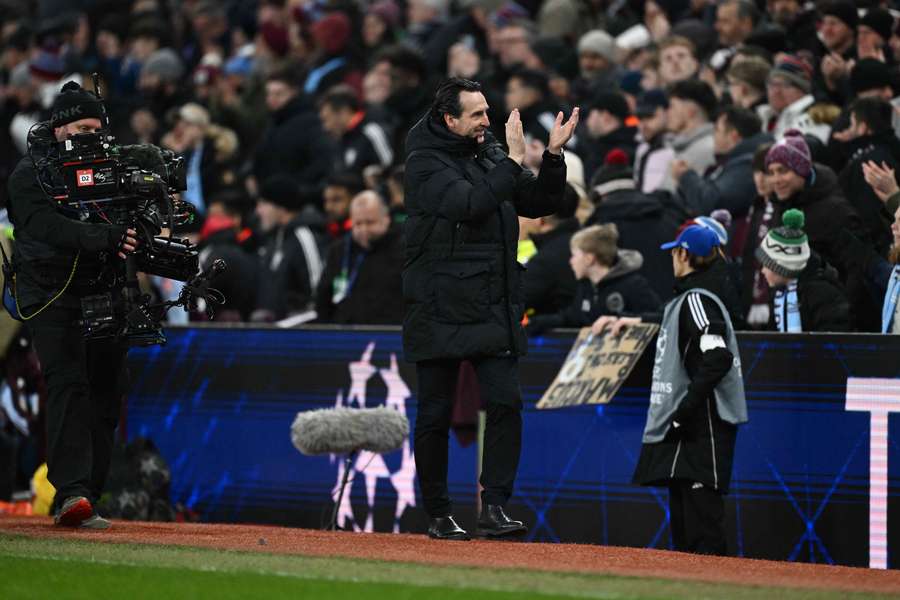 Unai Emery applauds fans after Aston Villa progressed in the Champions League.