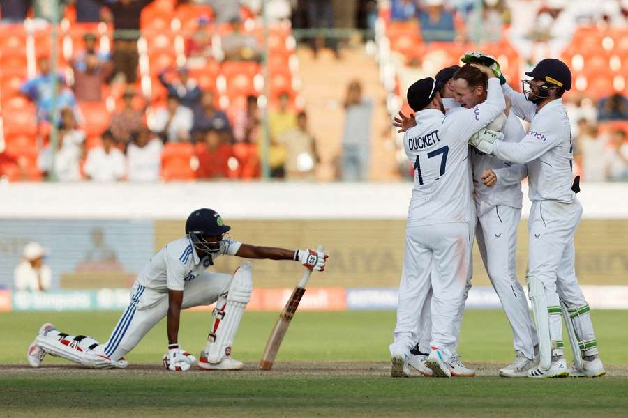 England's Tom Hartley celebrates with team-mates after taking the wicket of India's Srikar Bharat