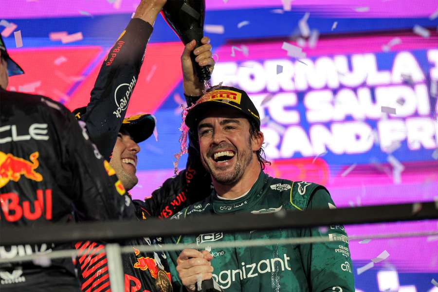 Red Bull Racing's Mexican driver Sergio Perez celebrates with Aston Martin's Spanish driver Fernando Alonso on the podium