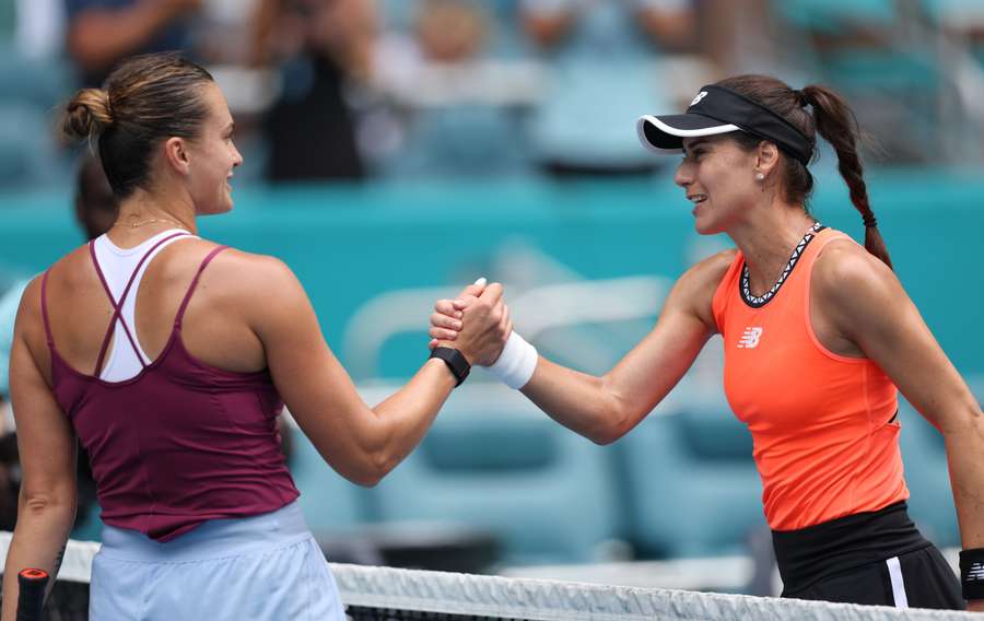 Sorana Cirstea of Romania shakes hands at the net after her straight-sets victory against Aryna Sabalenka