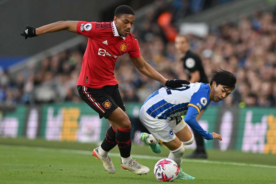 Anthony Martial vies for the ball with Kaoru Mitoma