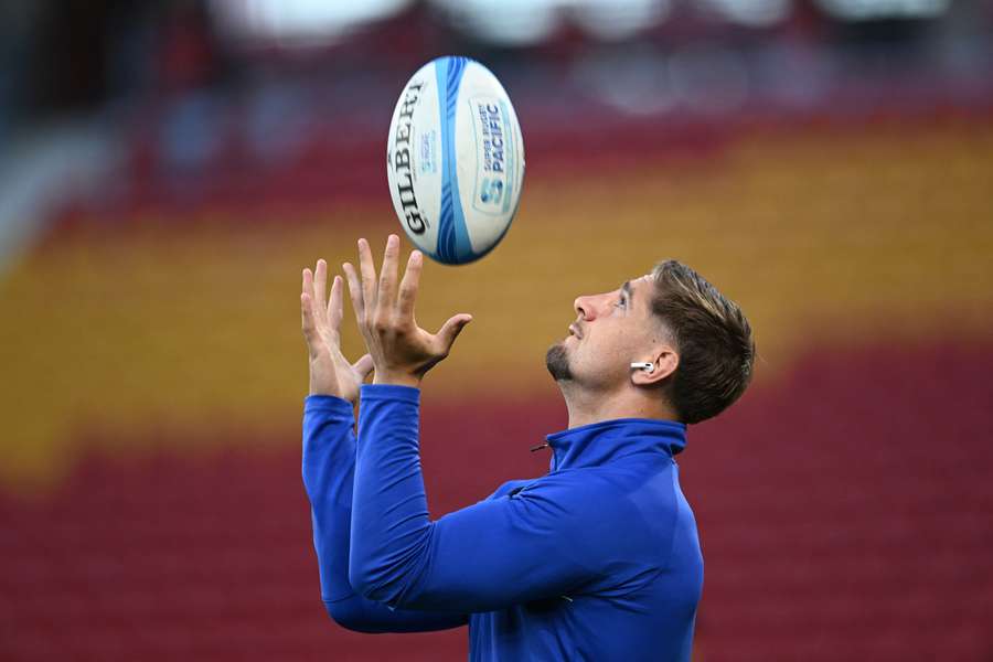 An injured Zac Lomax walks around Suncorp Stadium prior to their weekend game against the Reds.