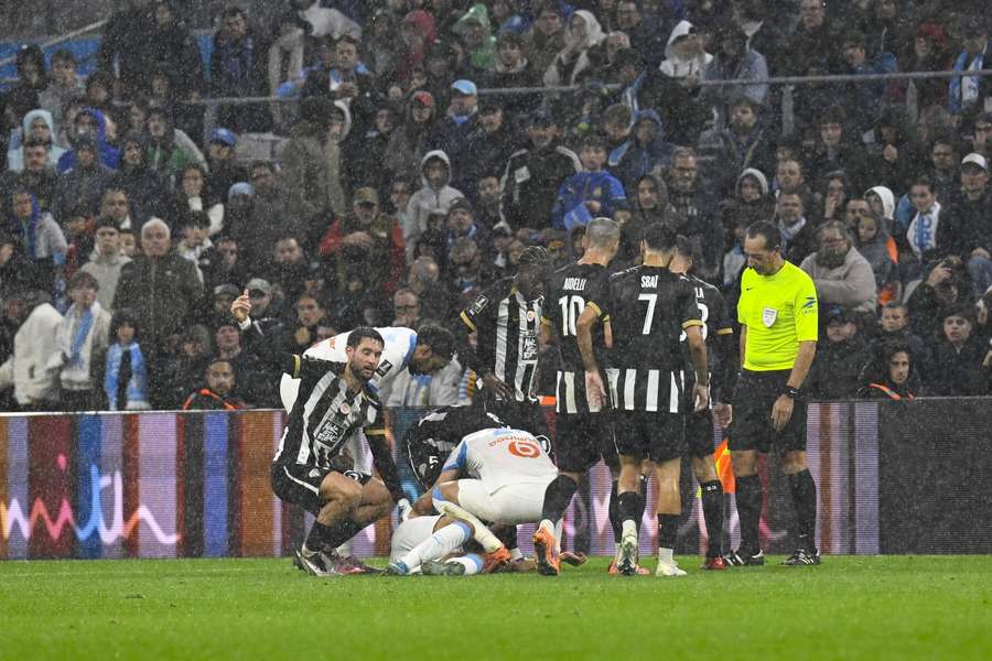 Players come to the aid of Bilal Nadir who suddenly collapsed during Marseille's clash with Angers Players come to the aid of Bilal Nadir who suddenly collapsed during Marseille's clash with Angers