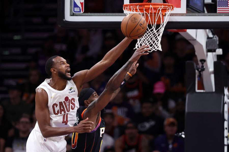 Cleveland Cavaliers forward Evan Mobley leaping over Phoenix Suns' Royce O'Neale
