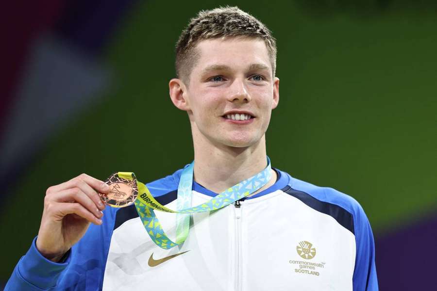 Bronze medallist Scotland's Duncan Scott celebrates on the podium