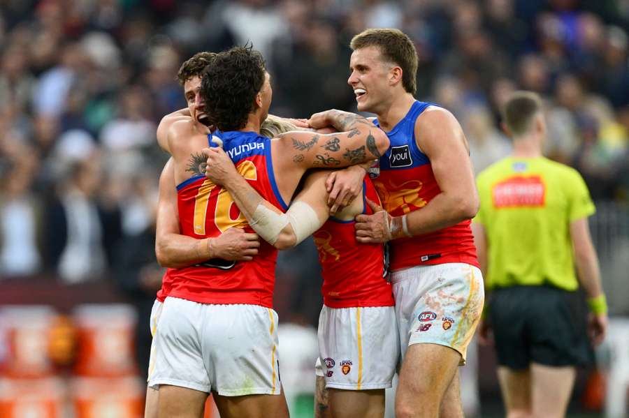 Hugh McCluggage and Brisbane teammates celebrate a third consecutive Premiership. Hugh McCluggage and Brisbane teammates celebrate a third consecutive Premiership.