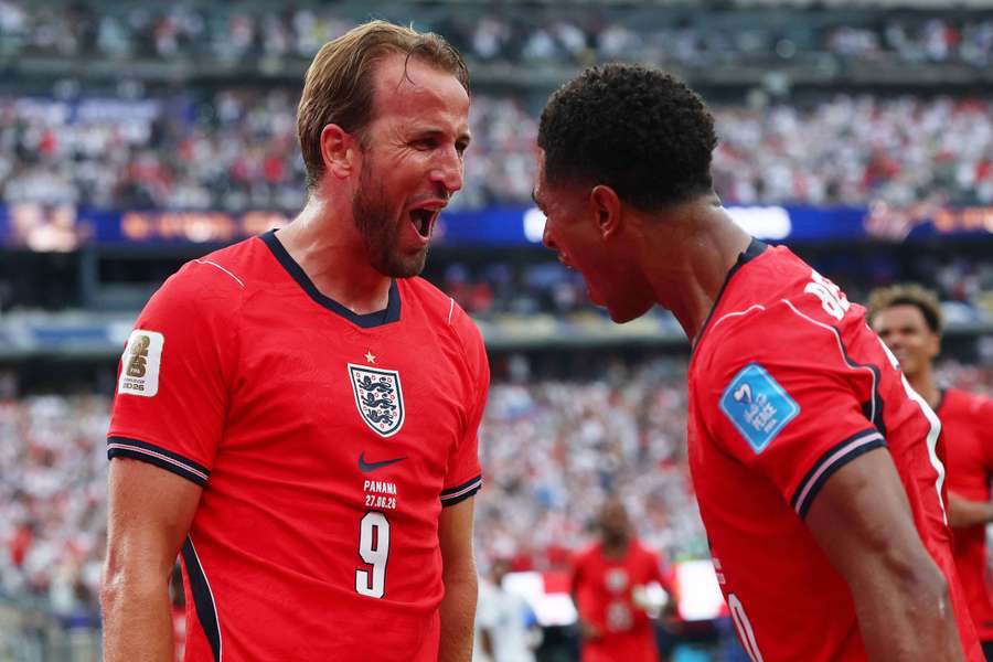 Harry Kane celebrates with Jude Bellingham after breaking England's World Cup goalscoring record