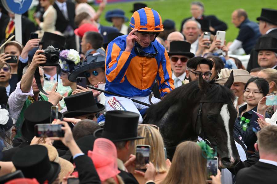 Jockey Ryan Moore returns to the winner's enclosure on Auguste Rodin after victory in the Derby