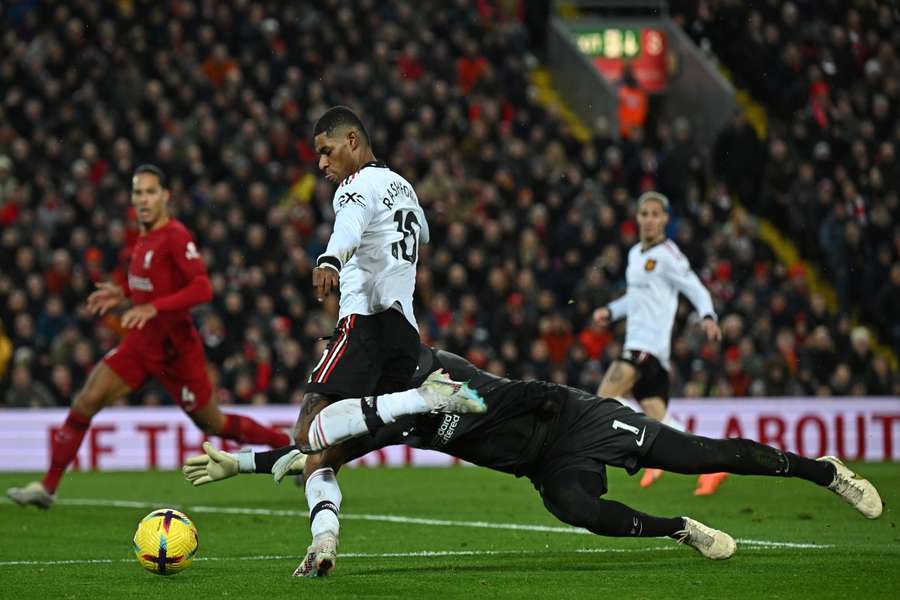 Rashford tries to take the ball around Liverpool goalkeeper Alisson