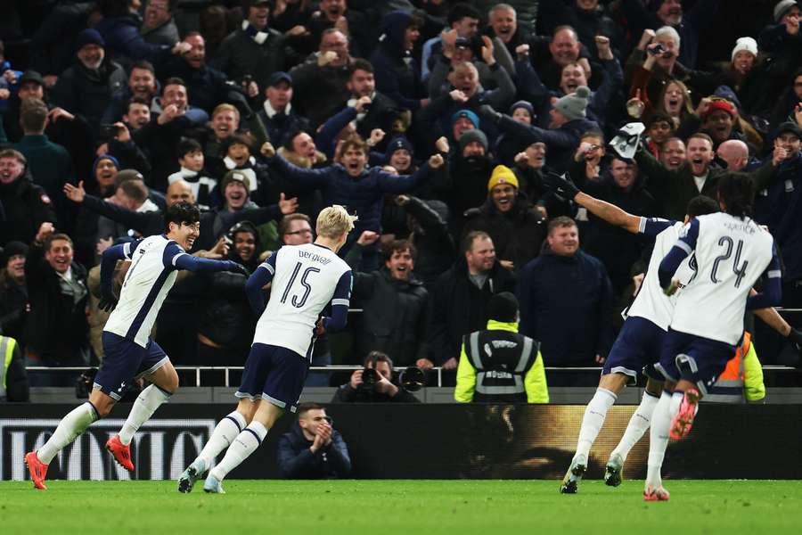 Son Heung-Min of Tottenham Hotspur (centre left) celebrates scoring his team's fourth goal