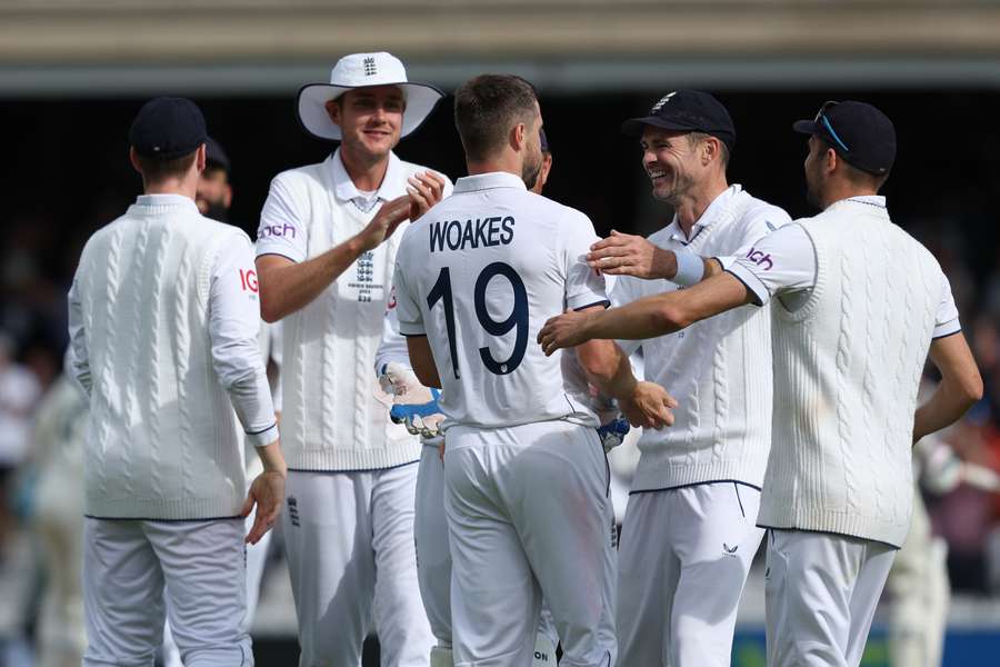 Chris Woakes is congratulated after taking the wicket of Australia's Mitchell Starc