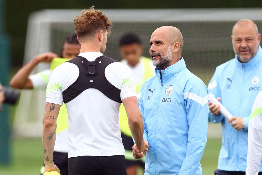 Guardiola talking to Stones in training