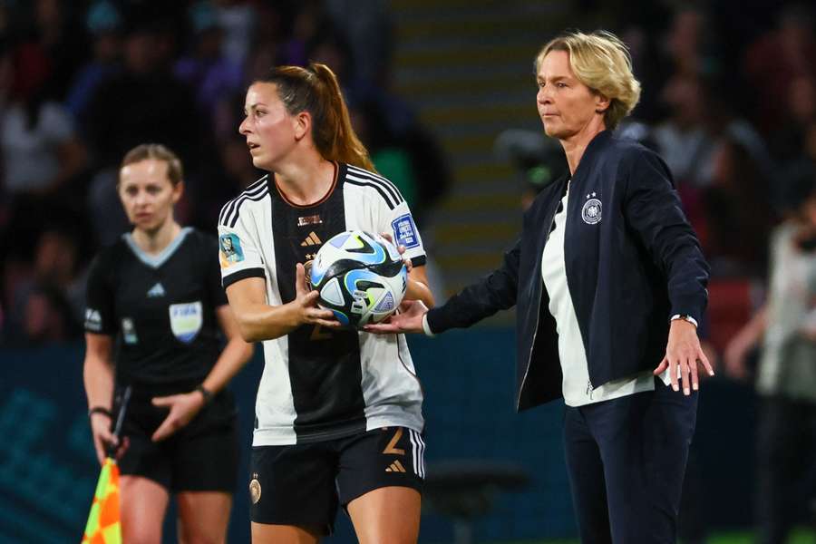 Germany's coach Martina Voss-Tecklenburg passes the ball to Germany's defender #02 Chantal Hagel 