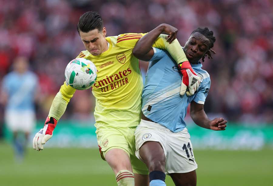 Kepa challenges Doku for the ball