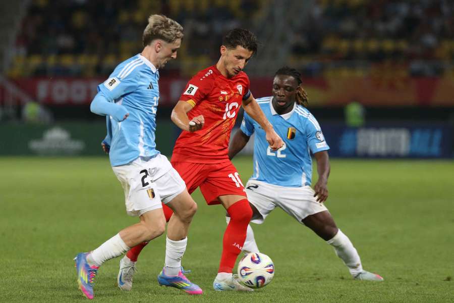 North Macedonia's Enis Bardhi in action with Belgium's Alexis Saelemaekers and Jeremy Doku
