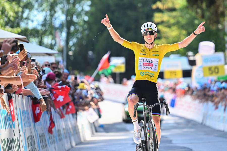 Tadej Pogacar celebrates as he crosses the line Tadej Pogacar celebrates as he crosses the line