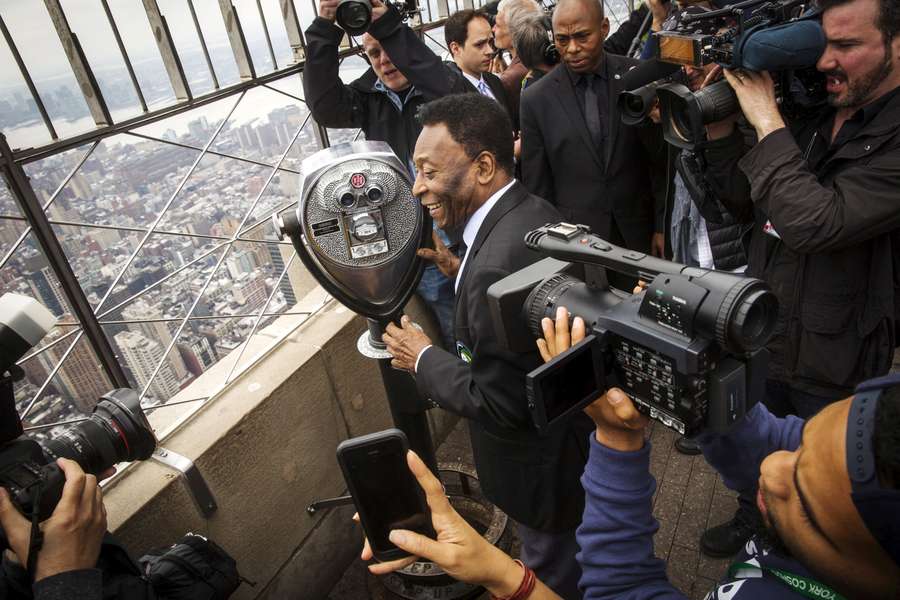 Pele laughs with photographers as he looks out on the city on top of the Empire State Building