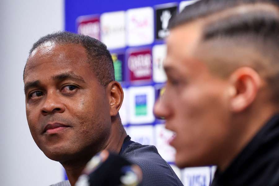 Indonesia manager Patrick Kluivert looks over at Dutch-Indonesian captain Jay Idzes during a press conference