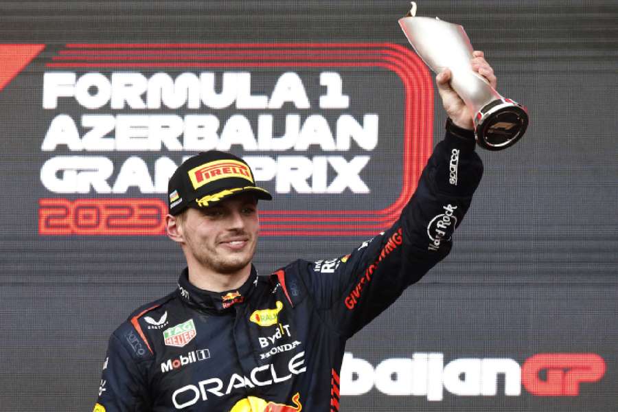 Red Bull's Max Verstappen celebrates with his trophy on the podium after finishing second