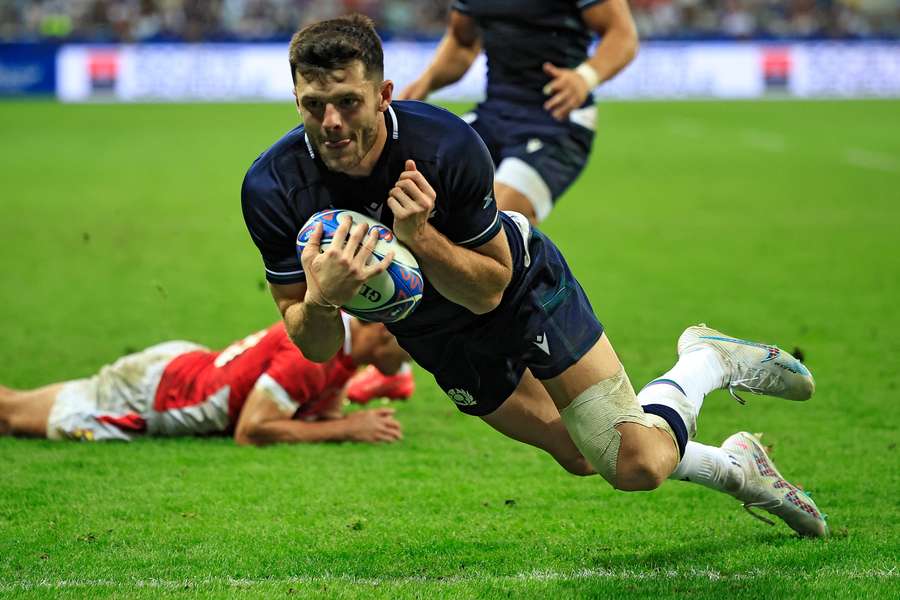Scotland's full-back Blair Kinghorn dives and scores a try