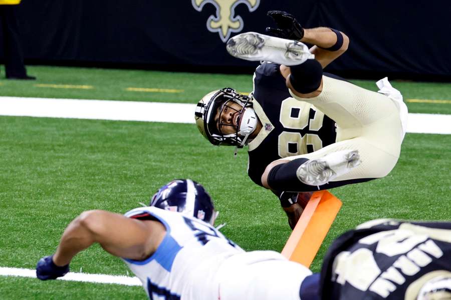 The Saints's Samson Nacua falls just short of a touchdown after Thomas Odukoya (bottom) tackles him following a 162-yard sprint