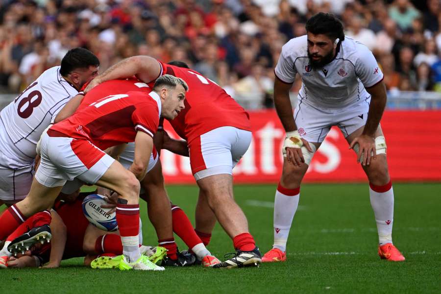 Wales' scrum-half Gareth Davies (L) passes the ball from a ruck