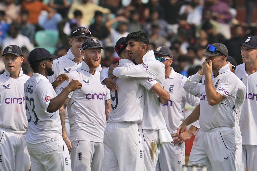 England's Shoaib Bashir, centre, celebrates the wicket of India's captain Rohit Sharma