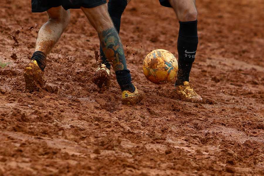 Locals play football in a dirt field in Sao Paulo, Brazil, on February 17th, 2024