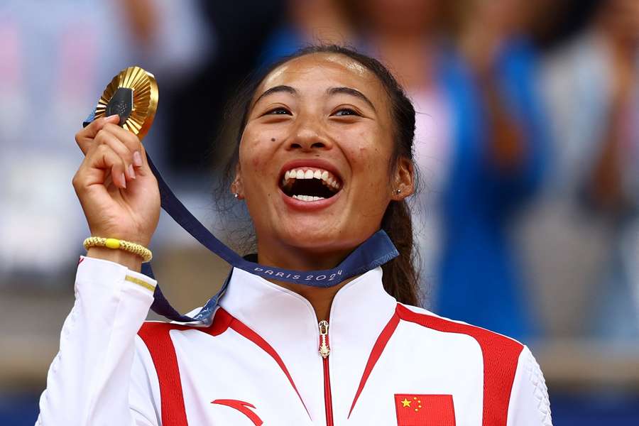 Zheng celebrates with her gold medal