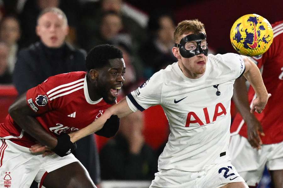 Tottenham Hotspur's Swedish midfielder #21 Dejan Kulusevski (R) is pulled back by Nottingham Forest's Belgian midfielder #05 Orel Mangala (L)