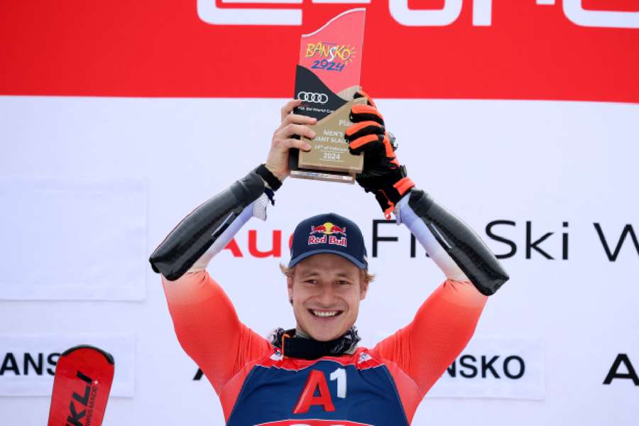 Switzerland's Marco Odermatt celebrates on the podium after winning the men's giant slalom in Bansko, Bulgaria