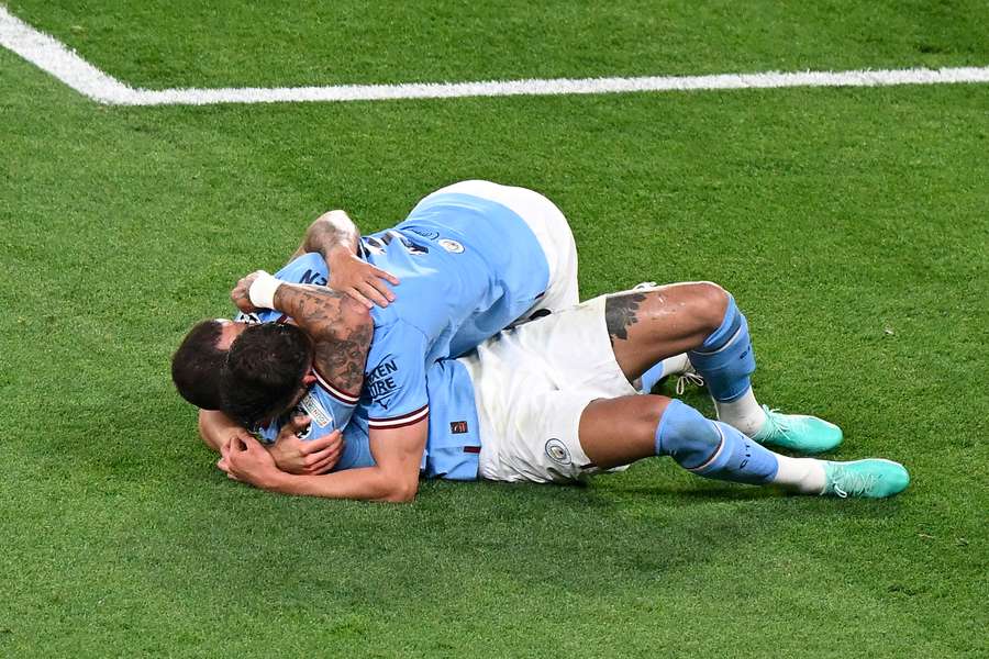 Phil Foden and Kyle Walker react as Man City win the Champions League