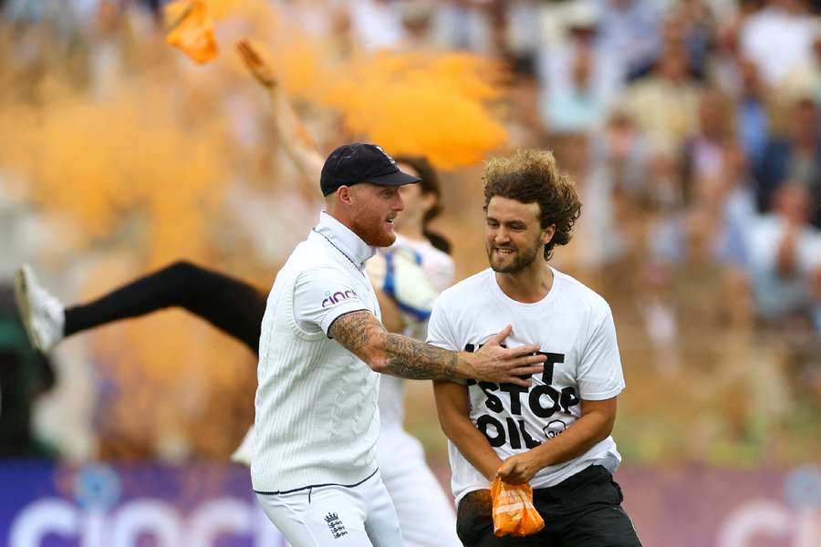 England captain Ben Stokes confronts one of the protestors