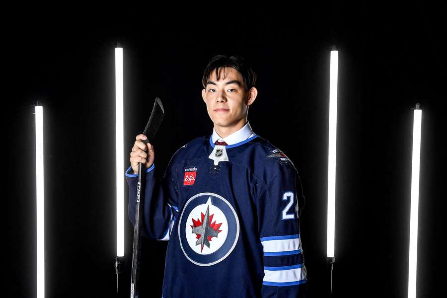 Jets' Kevin He posing for a photo during draft night