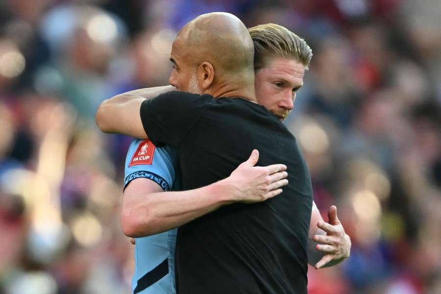 Kevin De Bruyne embraces Pep Guardiola after the FA Cup final defeat to Crystal Palace on Saturday