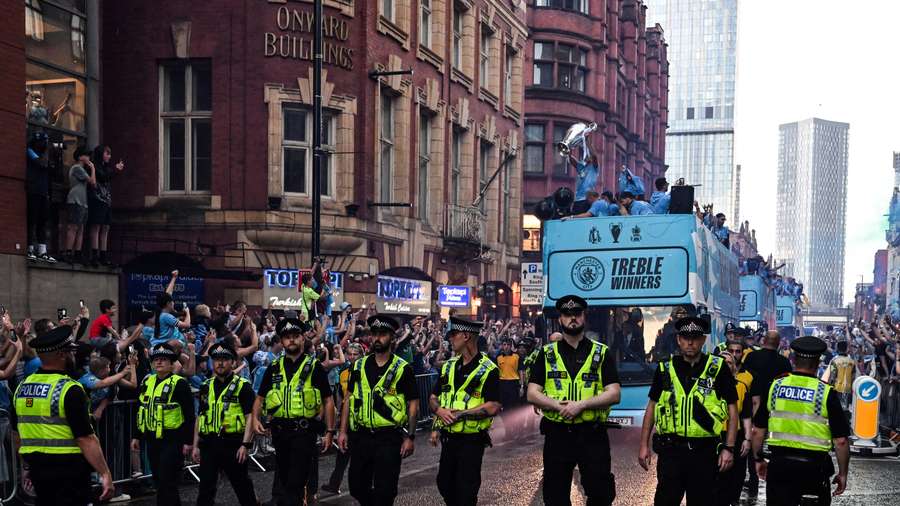 The players parade the Champions League, FA Cup and Premier League trophies