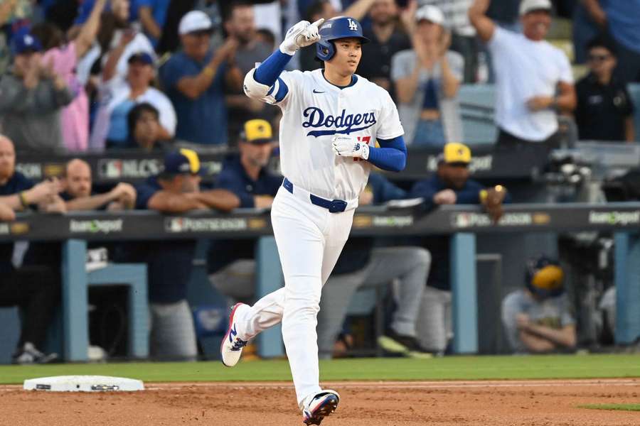Dodgers Shohei Ohtani reacts after hitting a home run in Game 4 of the NLCS against the Milwaukee Brewers