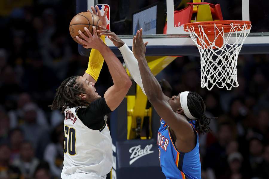 Aaron Gordon #50 of the Denver Nuggets goes to the basket against Luguentz Dort #5 of the Oklahoma City Thunder