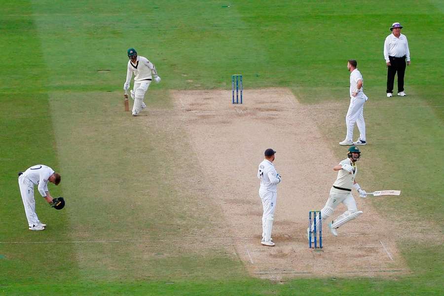 Pat Cummins and Nathan Lyon celebrate after winning the first Test