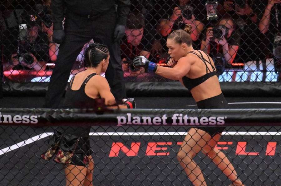 Returning Rousey, left, in the ring with Gina ‌Carano