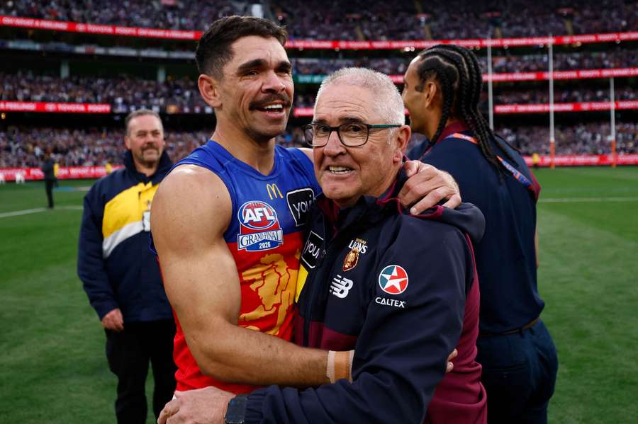Charlie Cameron and Chris Fagan embrace after their 2026 AFL Grand Final win. Charlie Cameron and Chris Fagan embrace after their 2026 AFL Grand Final win.