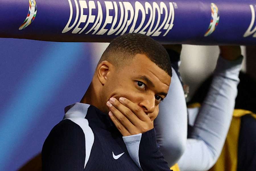 Mbappe watches on from the bench