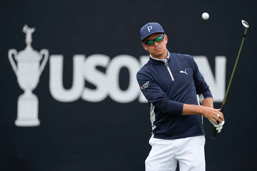 Rickie Fowler chips to the green on the 16th hole during a practice round for the US Open