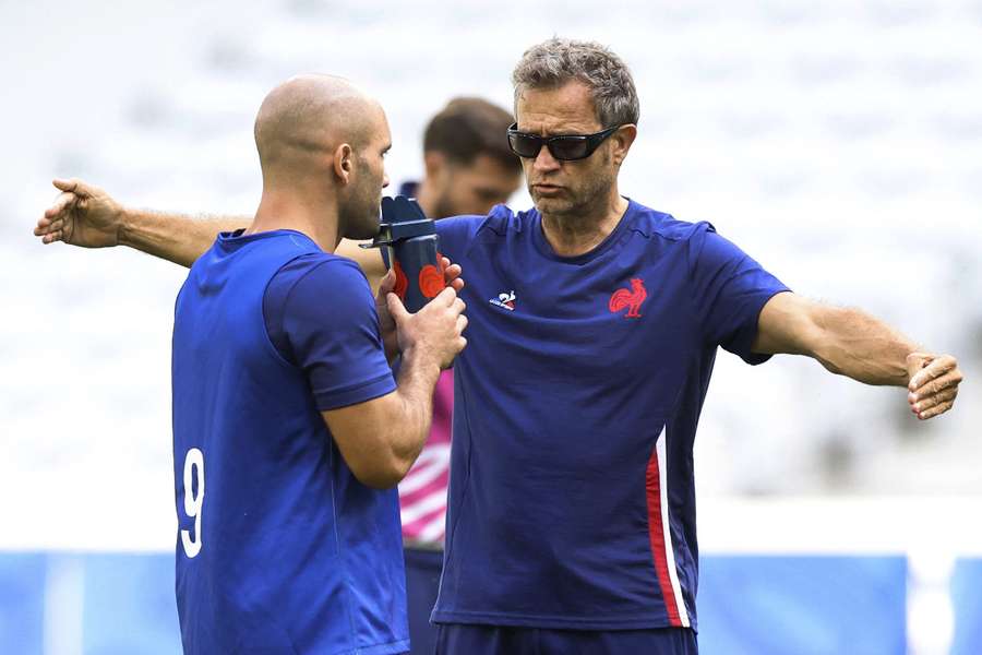France coach Fabien Galthie with Maxime Lucu during training