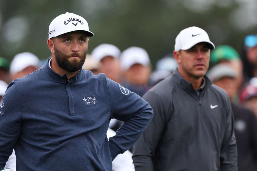 Jon Rahm of Spain and Brooks Koepka of the United States look on 